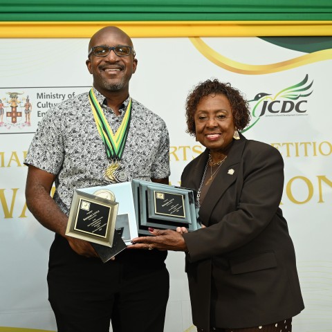 Dr. Sherard Little collecting his Overall Award from Minister of Culture, Gender, Entertainment, and Sport, the Honourable Olivia Grange at the 2026 Visual Arts Award Ceremony held on Thursday, October 1, 2026, at the Blue Mountain Suite of the Summit in Kingston. 