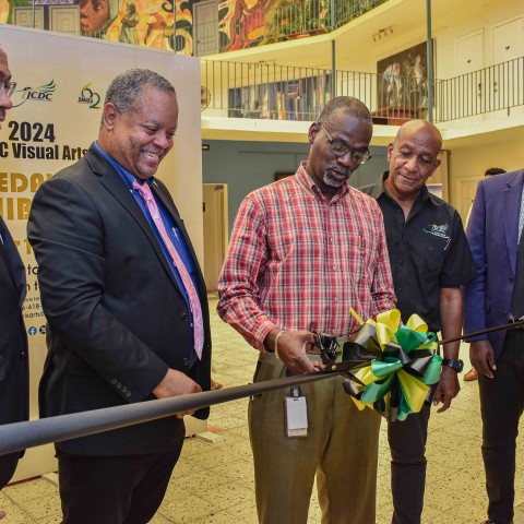 (From left) David Cummings, Vice President and Head of Real Estate and Project Finance at Sygnus Group; Andrew Brodber, Director of Arts Development and Training at the JCDC; Denzil Thorpe, Permanent Secretary in the Ministry of Culture, Gender, Entertainment and Sport; Lenford Salmon, Executive Director of the JCDC; and Dr. Winston Campbell, JCDC Visual Arts Specialist, cut the ribbon to open the 2024 JCDC Visual Arts Gold Medal Exhibition at the Olympia Art Centre in Kingston. Anticipation is now high for