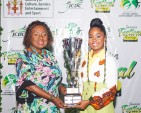 Minister of Culture, Gender, Entertainment and Sport Honourable Olivia Grange, OJ, CD, MP (left) presents the winner’s trophy to Abigail “Abi-D” Dunstan after she was declared winner of the Jamaica Festival Song Competition last year. 